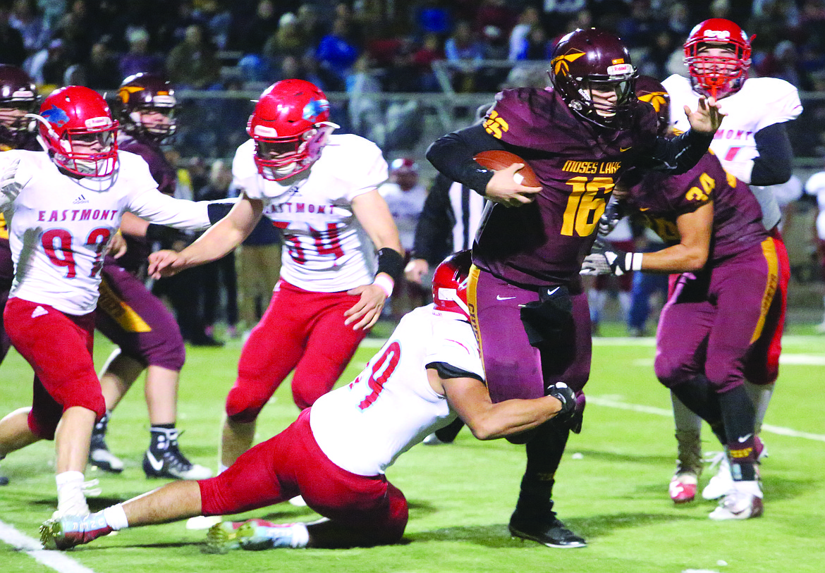 Connor Vanderweyst/Columbia Basin Herald
Moses Lake quarterback Logan Sperline is tackled for a minimal gain against Eastmont.