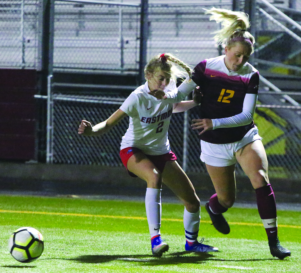 Connor Vanderweyst/Columbia Basin Herald
Moses Lake midfielder Morgan Skone jostles for possession next to Eastmont's Alyssa Konarek.