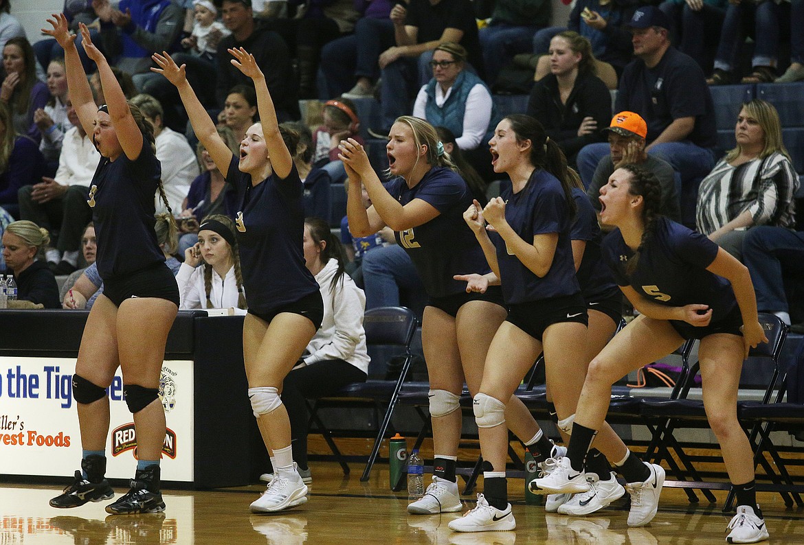 Timberlake High School volleyball players celebrate a point from the bench against Kellogg.