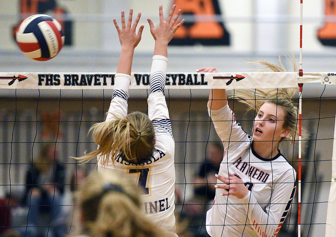 Flathead's Julia Burden (22) goes up for a kill against Missoula Sentinel's Jenna Swanson (7) at Flathead High School on Tuesday. (Casey Kreider/Daily Inter Lake)