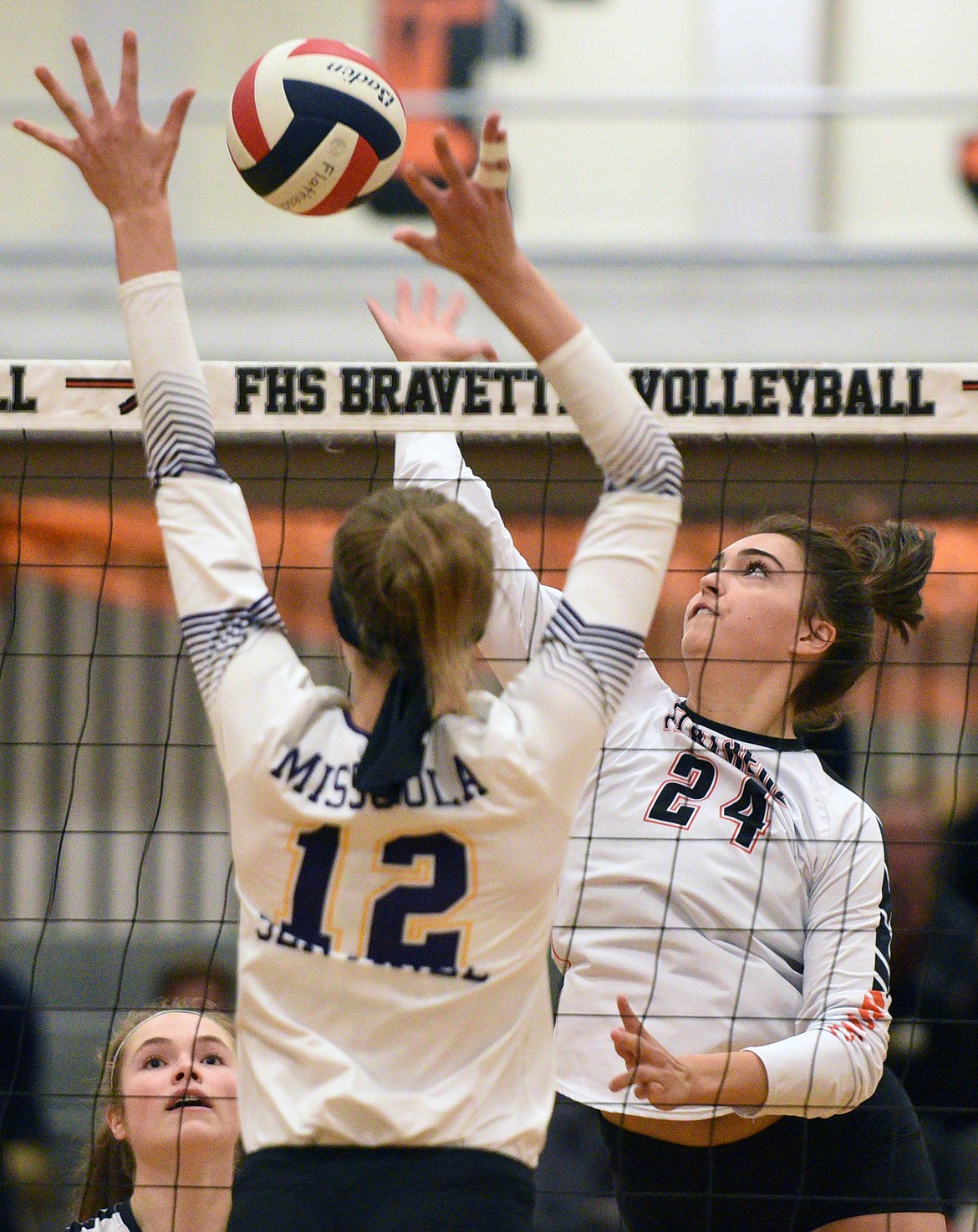 Flathead's Taylor Henley (24) goes up for a kill against Missoula Sentinel's Sierra Dennison (12) at Flathead High School on Tuesday. (Casey Kreider/Daily Inter Lake)