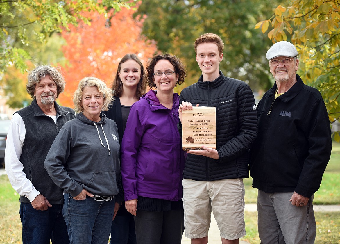 From left, Bill Nelson, Brooke Nelson, Hailey Hendrickson, Patricia Johnson, Evan Hendrickson, and Bruce Hirner gather for a portrait on 4th Avenue East in Kalispell on Oct. 5. Johnson and her son Evan Hendrickson were awarded the Best of Kalispell Urban Forestry Award 2018 recently for leading the efforts to have the 700 block of 4th Street East replanted with trees. (Brenda Ahearn/Daily Inter Lake)