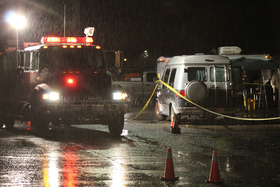 Law enforcement sets up next to the crime scene.