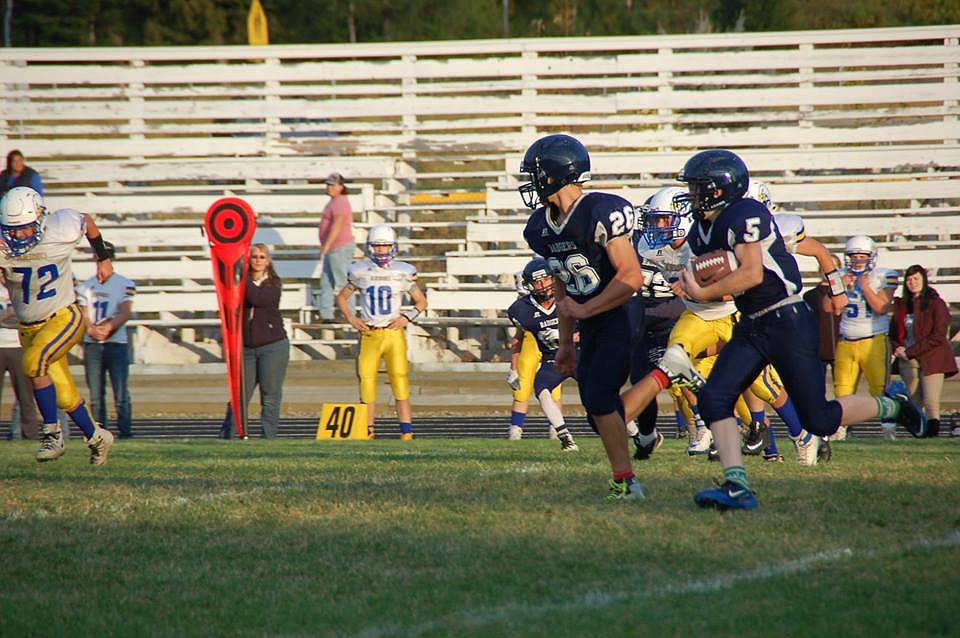 Kyle Smith leads Wilson Newel (5) upfield during the Badgers&#146; 22-12 junior varsity victory over Kellogg on Oct. 5.