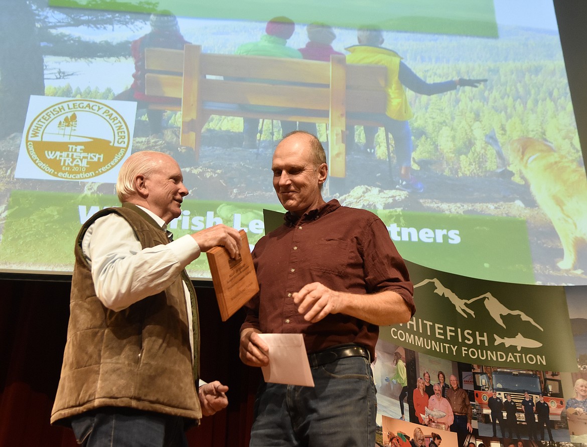 Ken Wessel, boardchair with the Whitefish Community Foundation presents the Biggest Catch Award to Mike Jopek, with Whitefish Legacy Partners. The award recognizes the Legacy Partners as the nonprofit with the most donors during the Great Fish Challenge. (Heidi Desch/Whitefish Pilot)