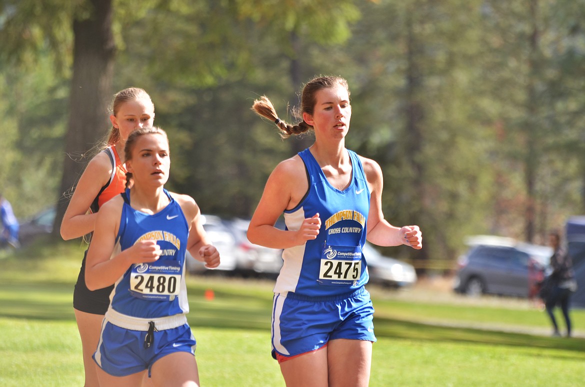 LEFT: Kacey VanZanten (2480) and Megan Baxter (2475) of Thompson Falls  run at the Western B/C Cross Country Divisonal cross country meet. Baxter placed 25th and Van Zanten was 31st. (Erin Jusseaume photos/Clark Fork Valley Press)