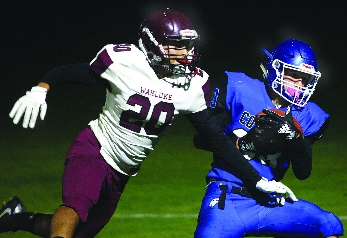 Rodney Harwood/Sun Tribune
Warden&#146;s Tyson Wall (33) hauls in a touchdown pass over Wahluke defender Jonathen Manzo during Friday&#146;s SCAC East game in Warden.