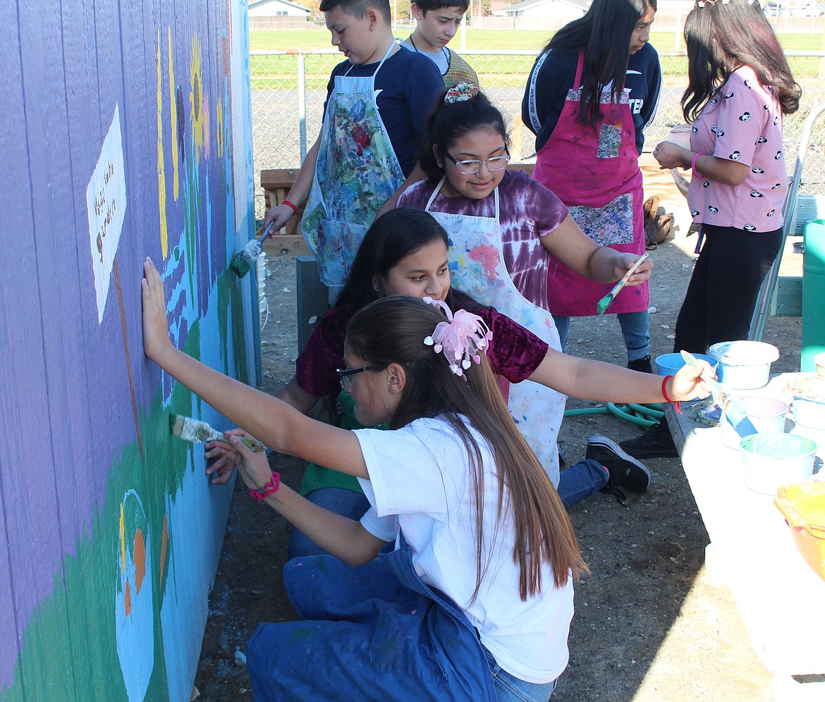 Cheryl Schweizer/Sun Tribune - McFarland Middle School seventh graders took over the painting part of a mural project in the community garden.