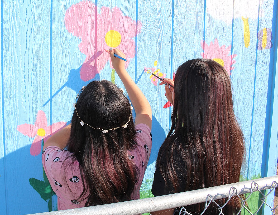 Cheryl Schweizer/Sun Tribune - McFarland Middle School seventh grade art students work on a mural project in the community garden.