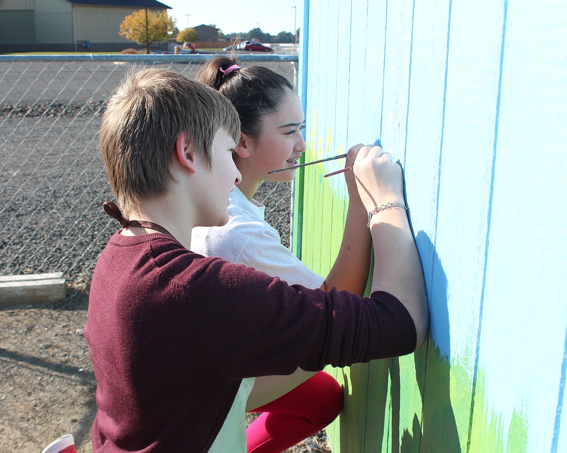 Cheryl Schweizer/Sun Tribune - McFarland Middle School seventh graders picked up their paintbrushes to work on a mural project in the community garden.