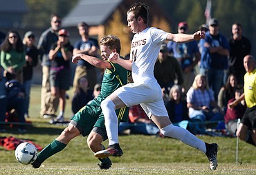 Whitefish's Casey Schneider (10) scores the lone goal of the game on a second-half strike past Frenchtown defender Tradd Richardson (14) at Smith Fields in Whitefish on Saturday. (Casey Kreider/Daily Inter Lake)