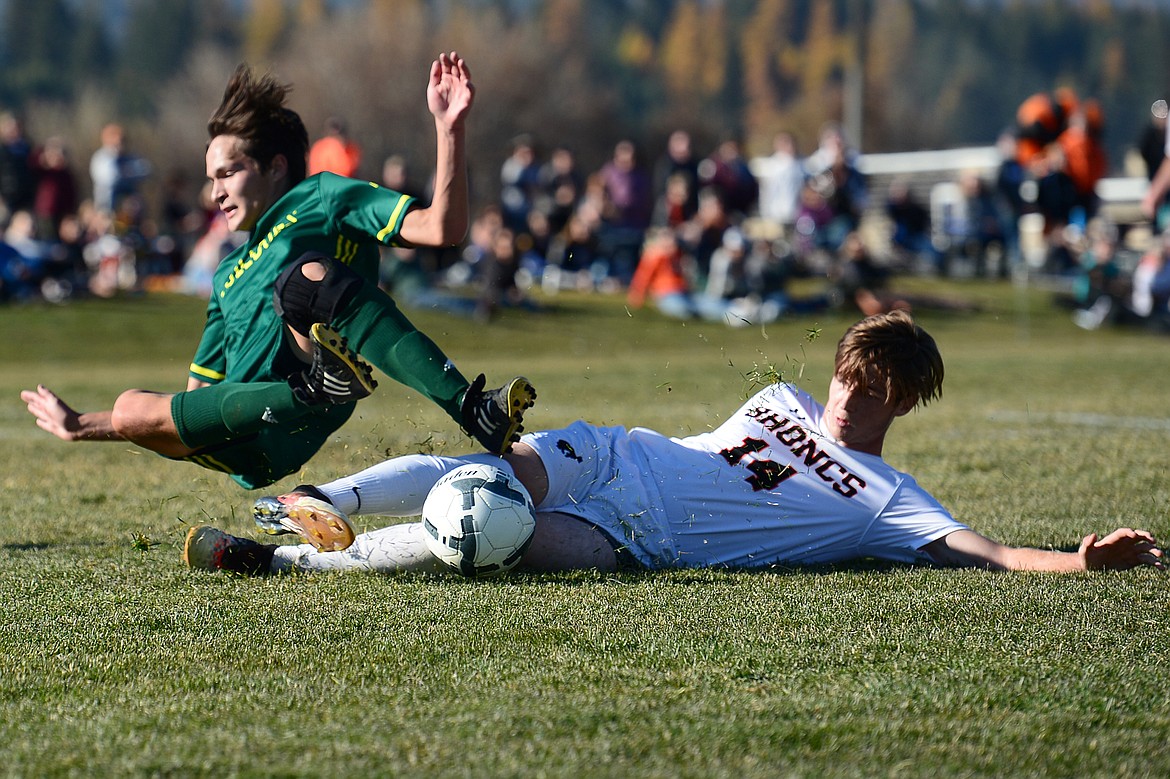 Whitefish's Joshua Gunderson (13) gets taken down by Frenchtown's Tradd Richardson (14) in the second half at Smith Fields in Whitefish on Saturday. (Casey Kreider/Daily Inter Lake)