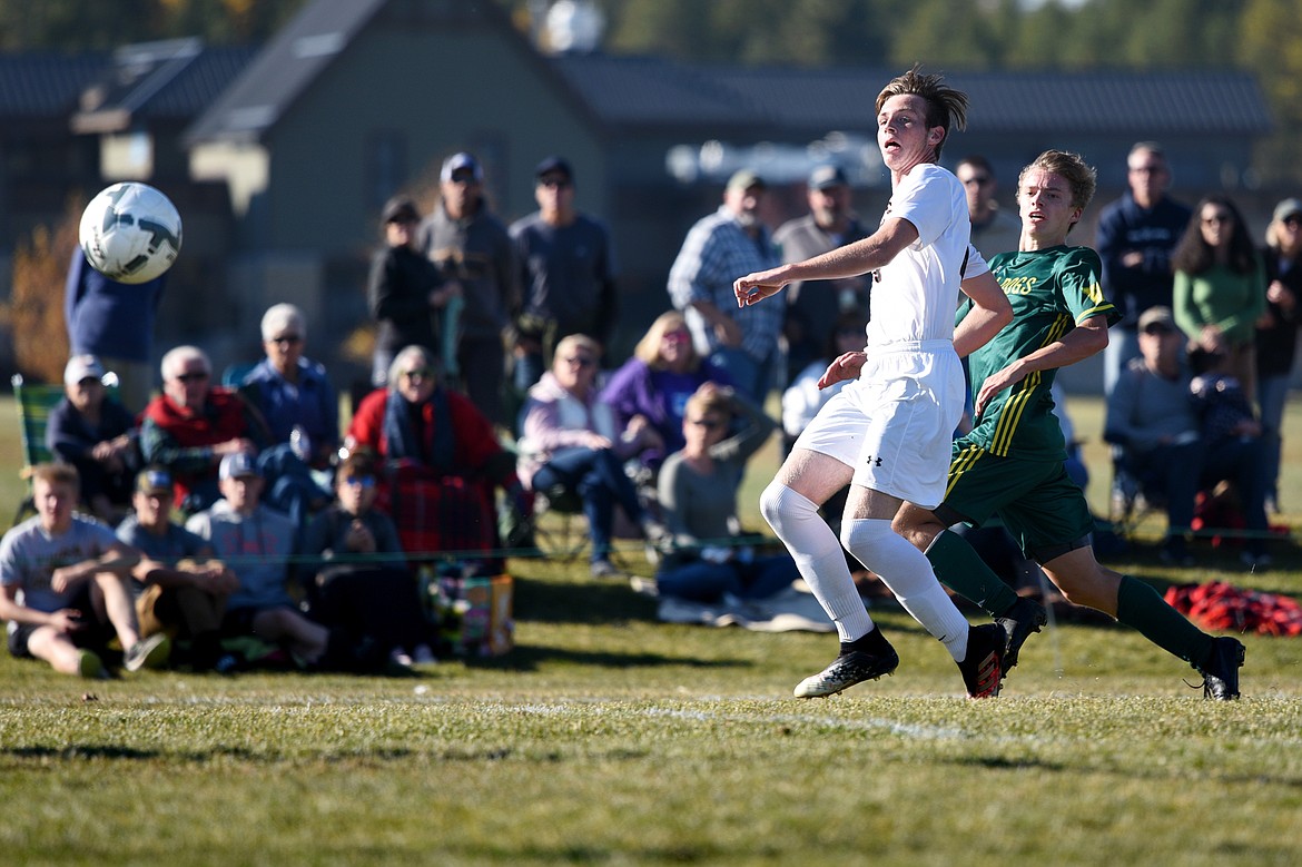 Whitefish forward Casey Schneider (10) and Frenchtown defender Tradd Richardson (14) watch the flight of Schneider's second-half, game-winning goal at Smith Fields in Whitefish on Saturday. (Casey Kreider/Daily Inter Lake)