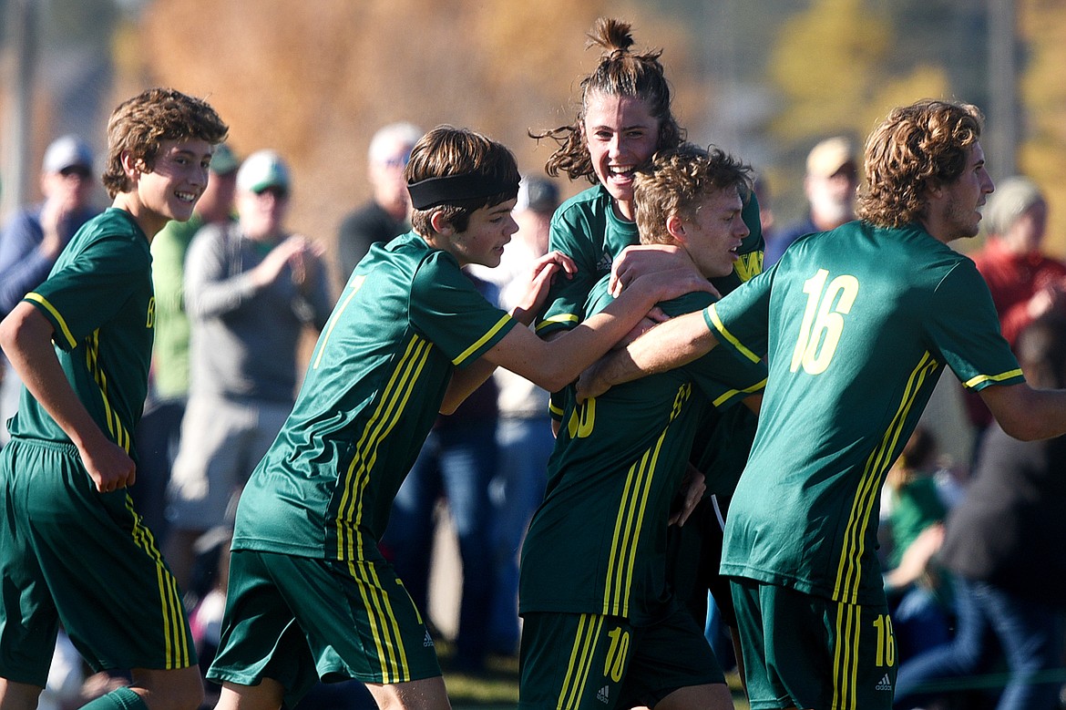 From left, Whitefish's Gabe Menicke (9), Ian Lacey (7), James Thompson (17), Casey Schneider (10) and Xander Burger (16) celebrate after Schneider's second-half goal against Frenchtown at Smith Fields in Whitefish on Saturday. (Casey Kreider/Daily Inter Lake)