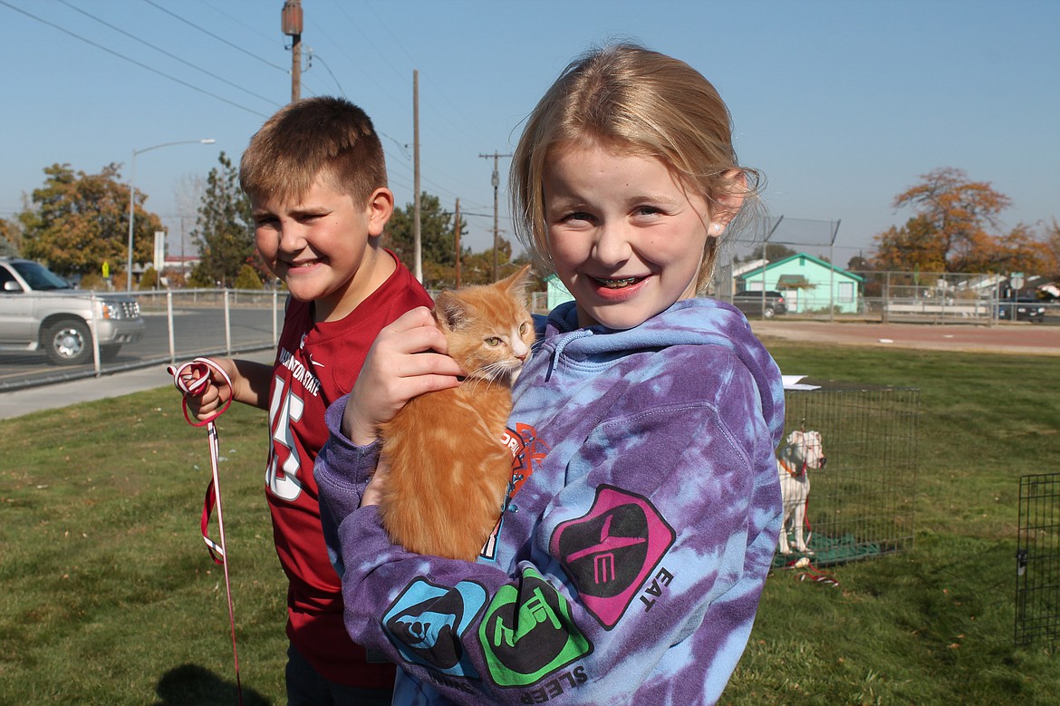 Joel Martin/Columbia Basin Herald
Dallie shows off a kitten named Butterball, with C.J. behind her holding a leash with golden retriever mix Jordan (not pictured) at the other end.