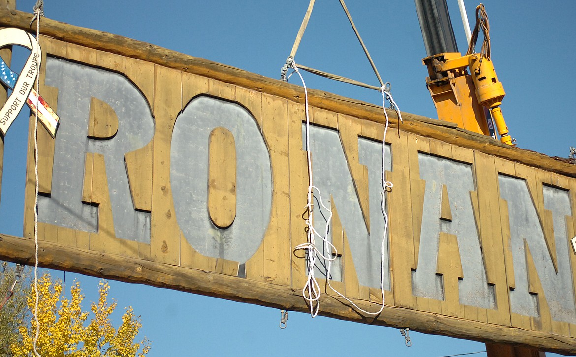 Employees of Mission Valley Power and Access Montana removed the 16-year-old sign from the archway leading to downtown Ronan on Oct. 17 to allow for renovation by members of the Ronan High School Class of 2018 and Class of 2019. (Joe Sova photos/Lake County Leader)