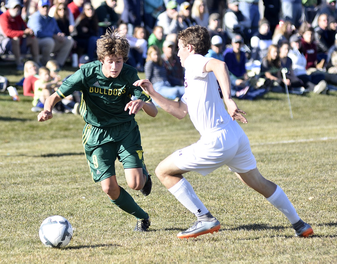 Bulldog Gabe Menicke moves around a Frenchtown player during the second half of the semifinal playoff game Saturday at Smith Fields. (Heidi Desch/Whitefish Pilot)