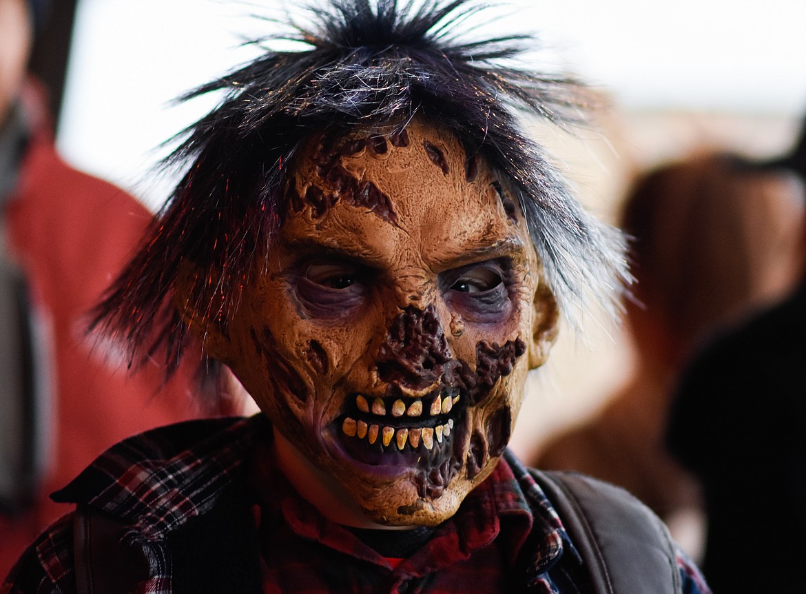 A scary-looking youngster searches for treats in downtown Whitefish during Halloween Wednesday. (Daniel McKay/Whitefish Pilot)