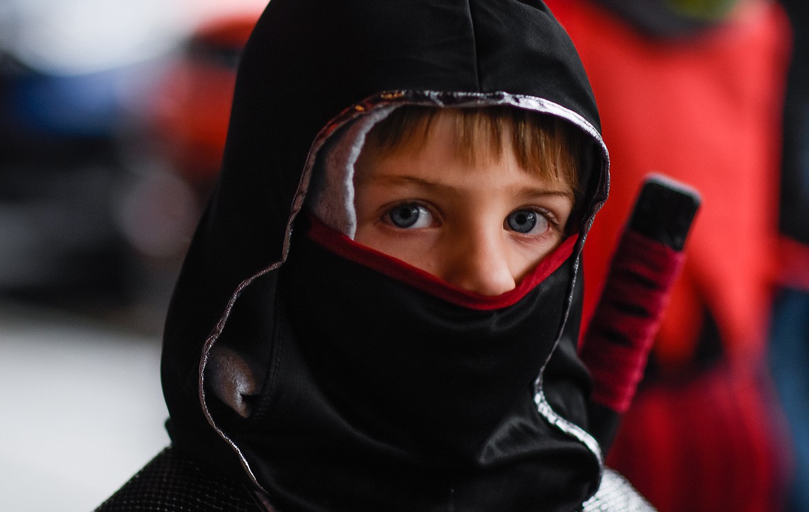 A ninja sneaks around looking for candy in downtown Whitefish during Halloween Wednesday. (Daniel McKay/Whitefish Pilot)