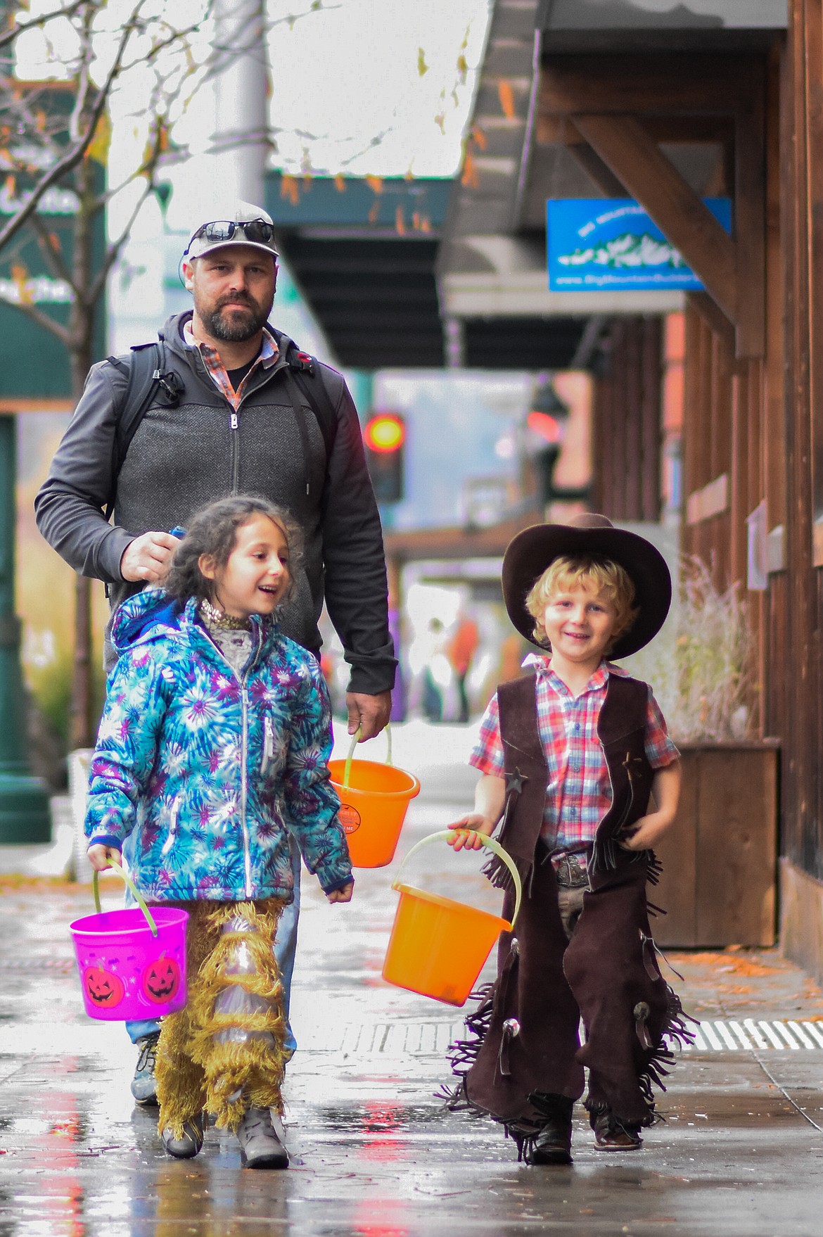 Some rough-n-tumblin' cowboys and cowgirls look for candy in downtown Whitefish during Halloween Wednesday. (Daniel McKay/Whitefish Pilot)