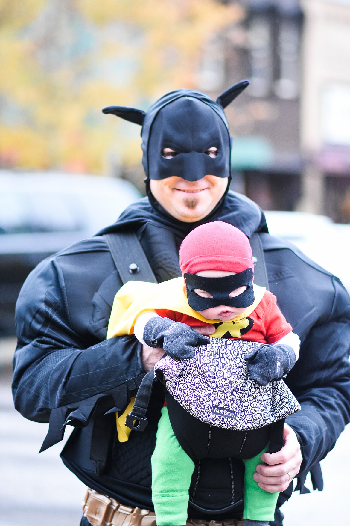 Batman poses with a sleepy Robin in downtown Whitefish during Halloween Wednesday. (Daniel McKay/Whitefish Pilot)