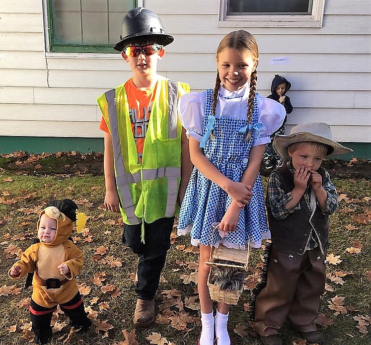 Zoe (left) won in the 0-2 age group, Dalton won for his construction costume in the 6-9 group, Perri won as Dorothy in the Wizard of Oz in ages 10-and-older and Leroy (far right) won as a cowboy for ages 3-5. (Photo courtesy of Florence Evans)
