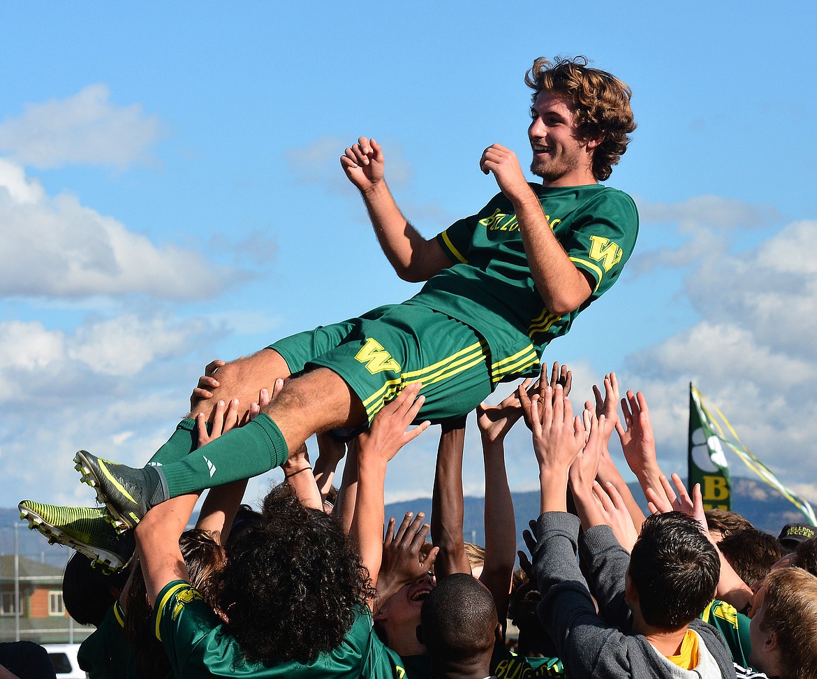 Following Whitefish&#146;s win, the team lifts Bulldog Xander Burger Saturday at Smith Fields. (Photo courtesy Jeff Doorn)