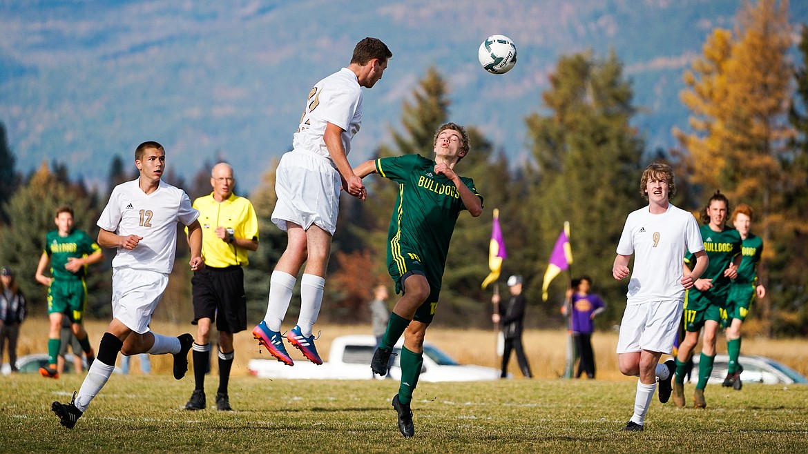 Casey Schneider fights with a Polson defender for the header during the Class A state title match Saturday.