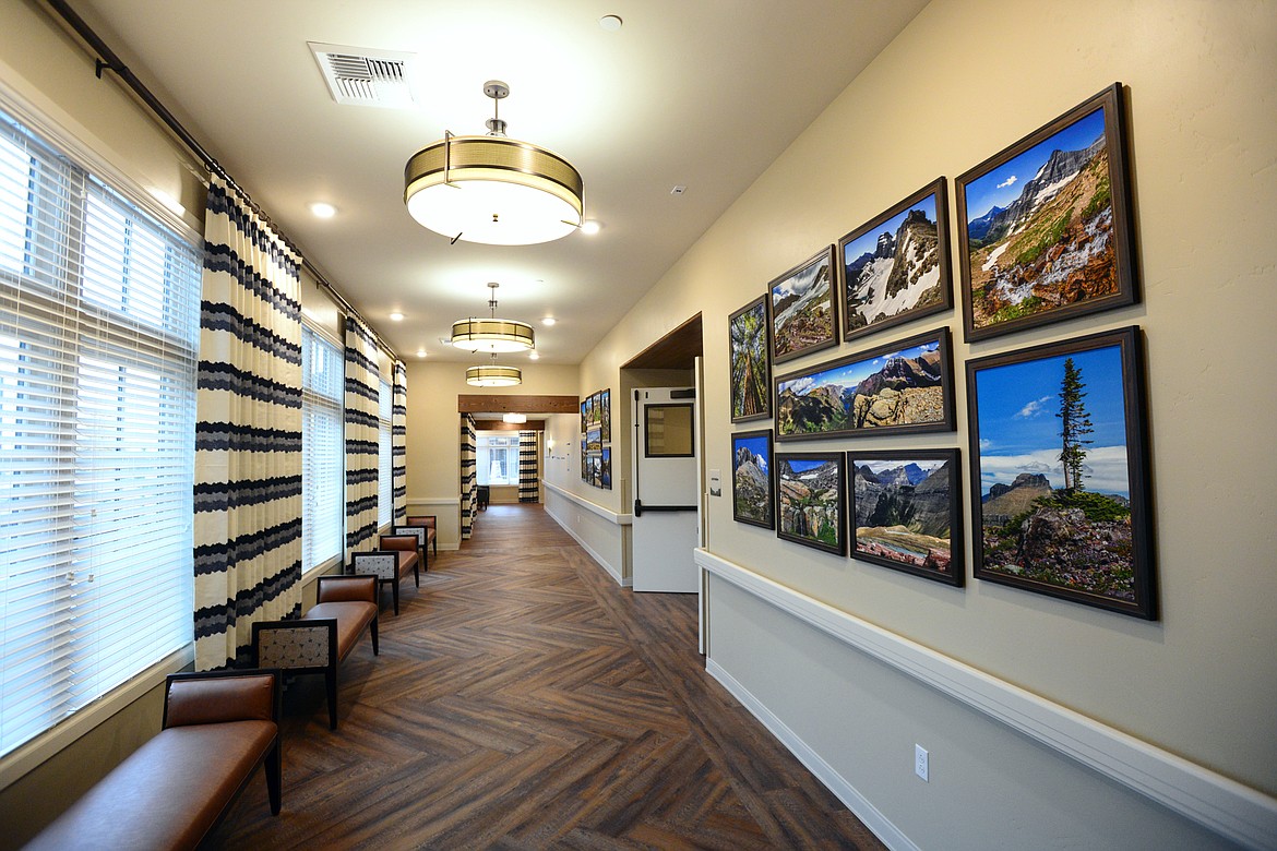 A bright hallway adorned with work from local artist Bret Bouda connects the apartments to the chapel, swimming pool and other facilities. (Casey Kreider/Daily Inter Lake)