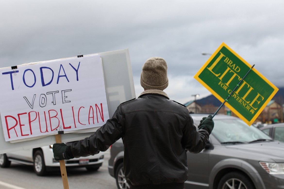 Photo by Duane Rasmussen
Gary Hourigan waves signs at the northwest corner of Appleway Avenue and U.S. 95 Tuesday afternoon.