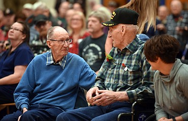 Special Guest Veterans Jack Dunne, center, and Jim Crowe, right, share a moment during the Veterans Day Assembly on Friday, November 9. Both men are residents at the Montana Veterans Home. This year Dunne, Crowe, and Bob Adams were honored at the annual assembly.(Brenda Ahearn/Daily Inter Lake)
