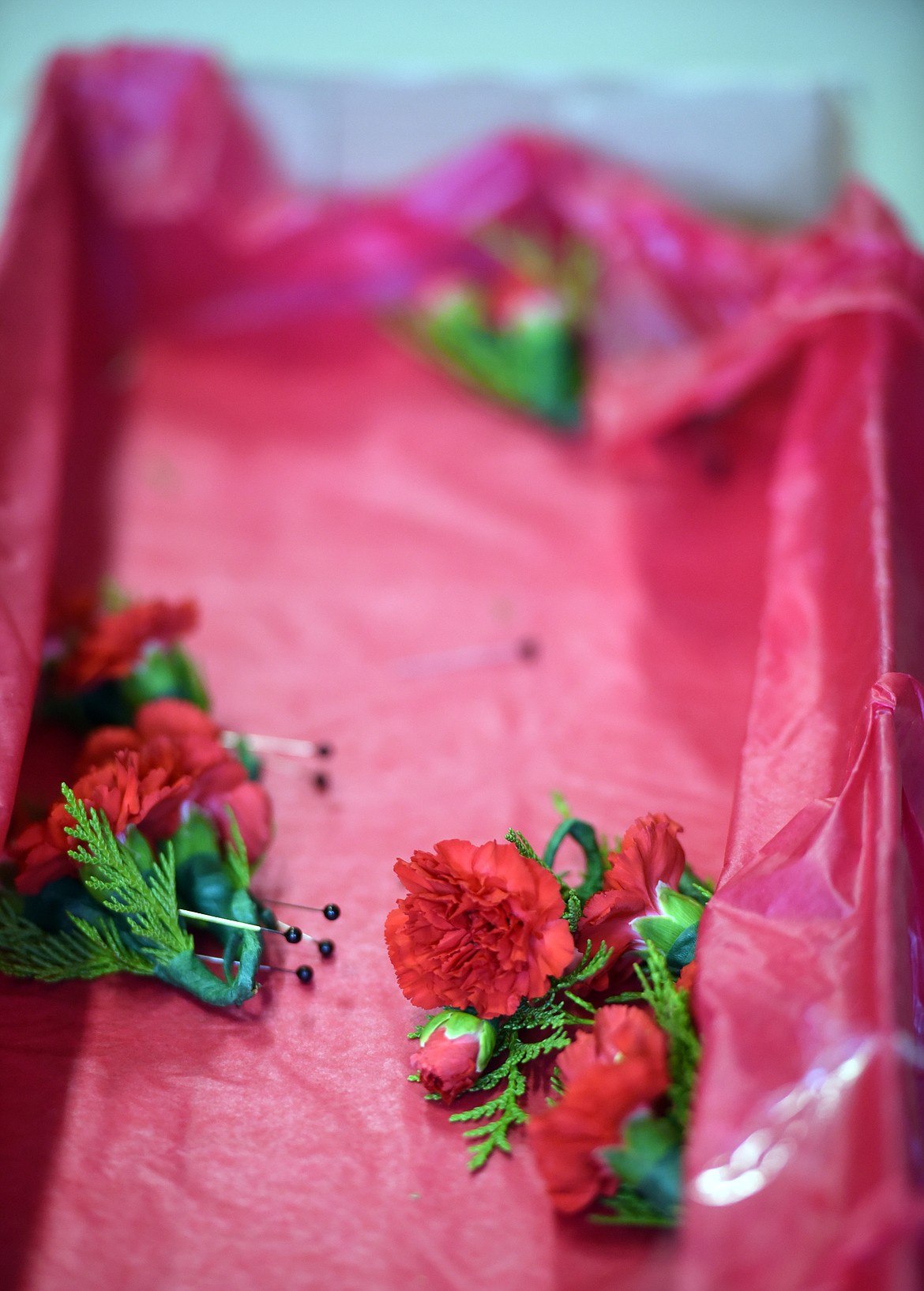 The box of corsages is nearly empty at the Veterans Day Assembly on Friday, November 9.(Brenda Ahearn/Daily Inter Lake)