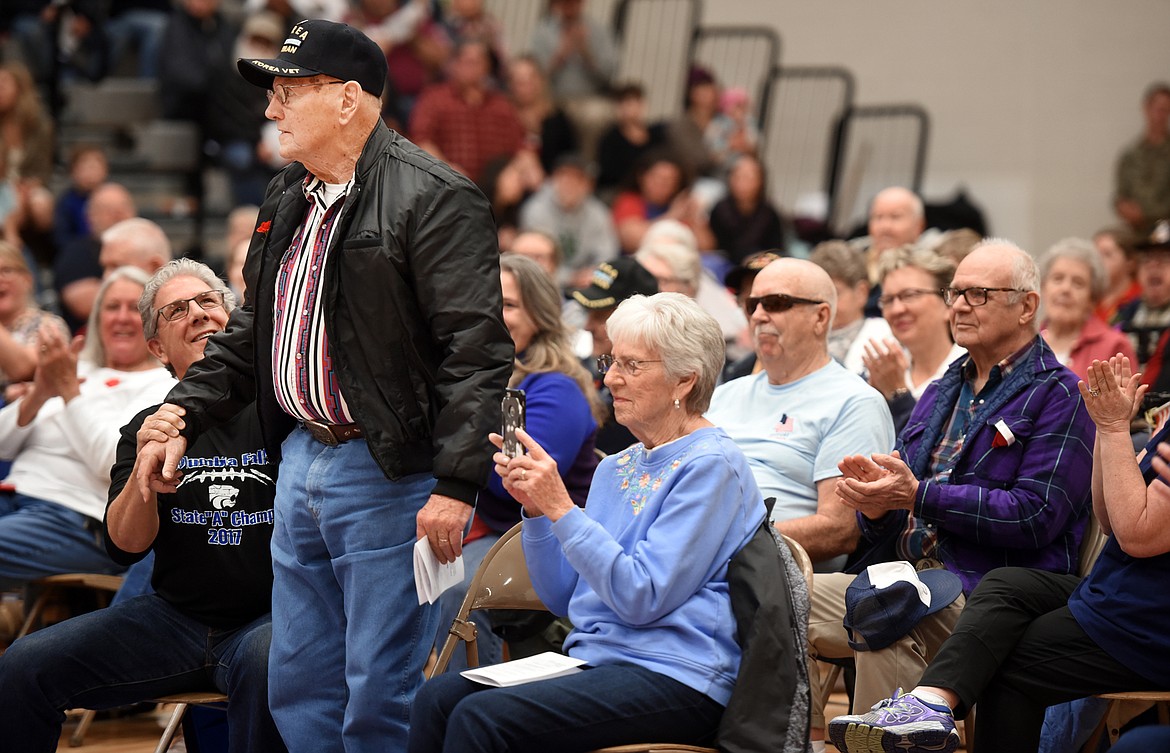 Air Force Veteran Bob Adams stands for the applause of the crowd after a brief biographical essay was read about him and two other at the Veterans Day Assembly at Columbia Falls High School on Friday, November 9. Veterans Day this year is Sunday, November 11. It will also mark the 100th anniversary of Armistice of 11 November 1918 which ended the fighting between the Allies and Germany in World War I.(Brenda Ahearn/Daily Inter Lake)