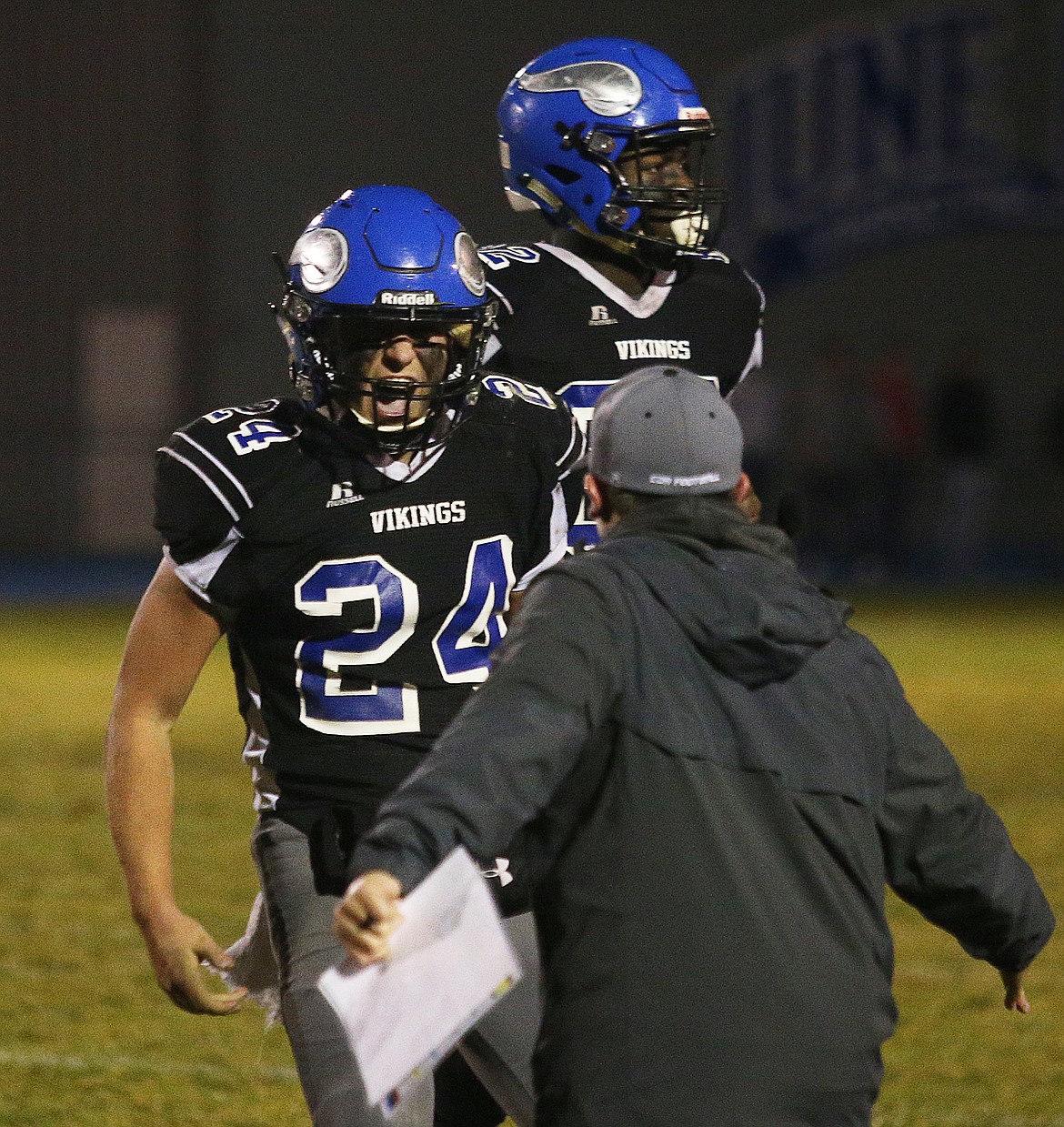 Coeur d&#146;Alene&#146;s Garrett Hagel celebrates a turnover with an assistant coach in a state 5A football quarterfinal game against Borah on Friday night at Viking Field.