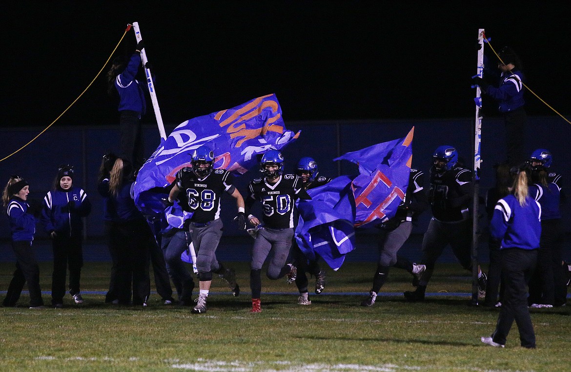 The Coeur d&#146;Alene football team enters the field after halftime in Friday&#146;s game against Borah.