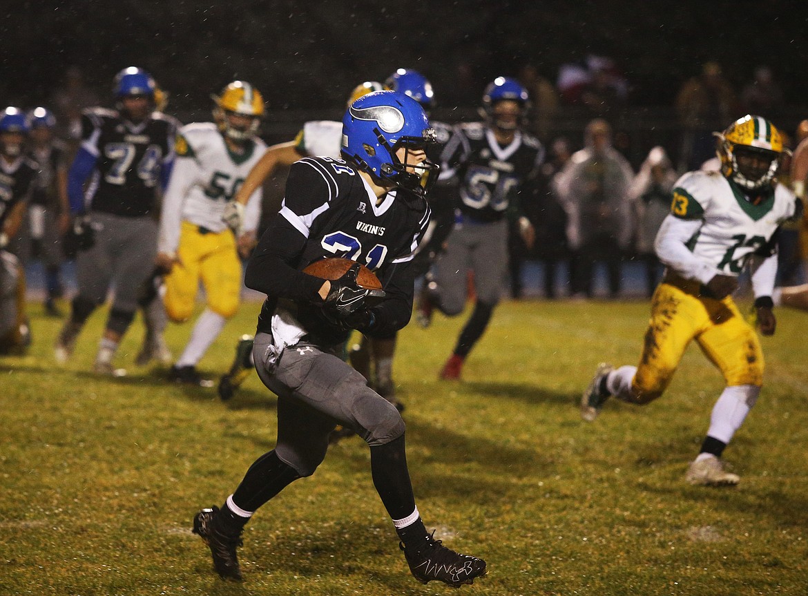 Coeur d&#146;Alene wide receiver Colbey Nosworthy catches the ball and runs upfield against Borah.