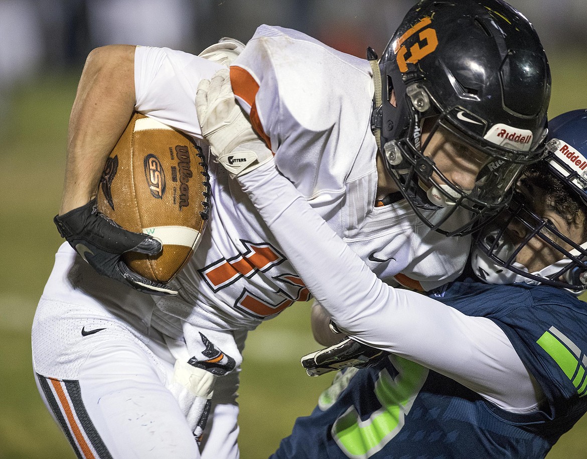 DARIN OSWALD/Idaho Statesman
Mountain View defensive back Alec Simeon tackles Post Falls receiver Tommy Hauser on a quick outside pass during a state 5A football quarterfinal game in Meridian on Friday.