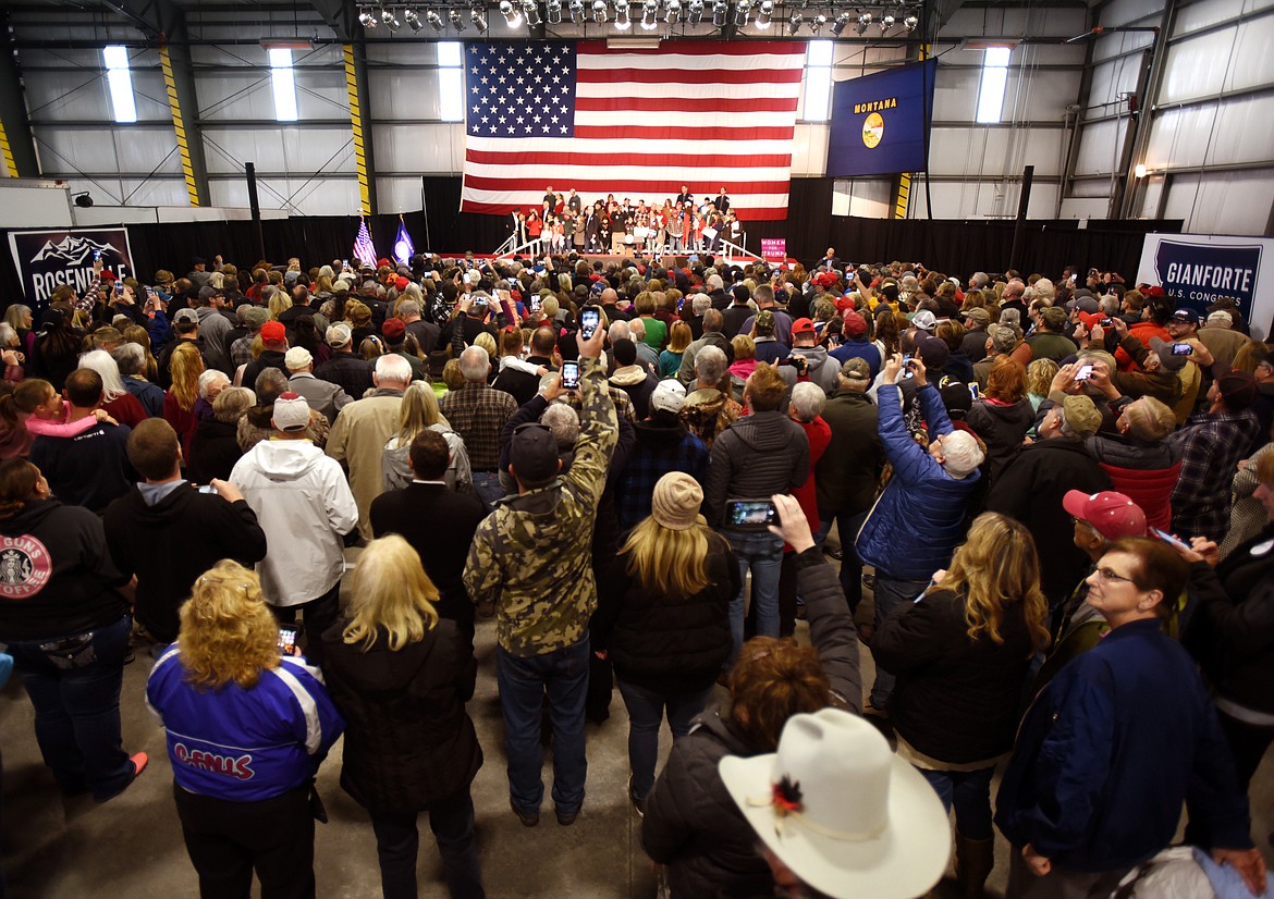 A crowd of more than 1,000 people fills a hangar at Glacier Park International Airport.