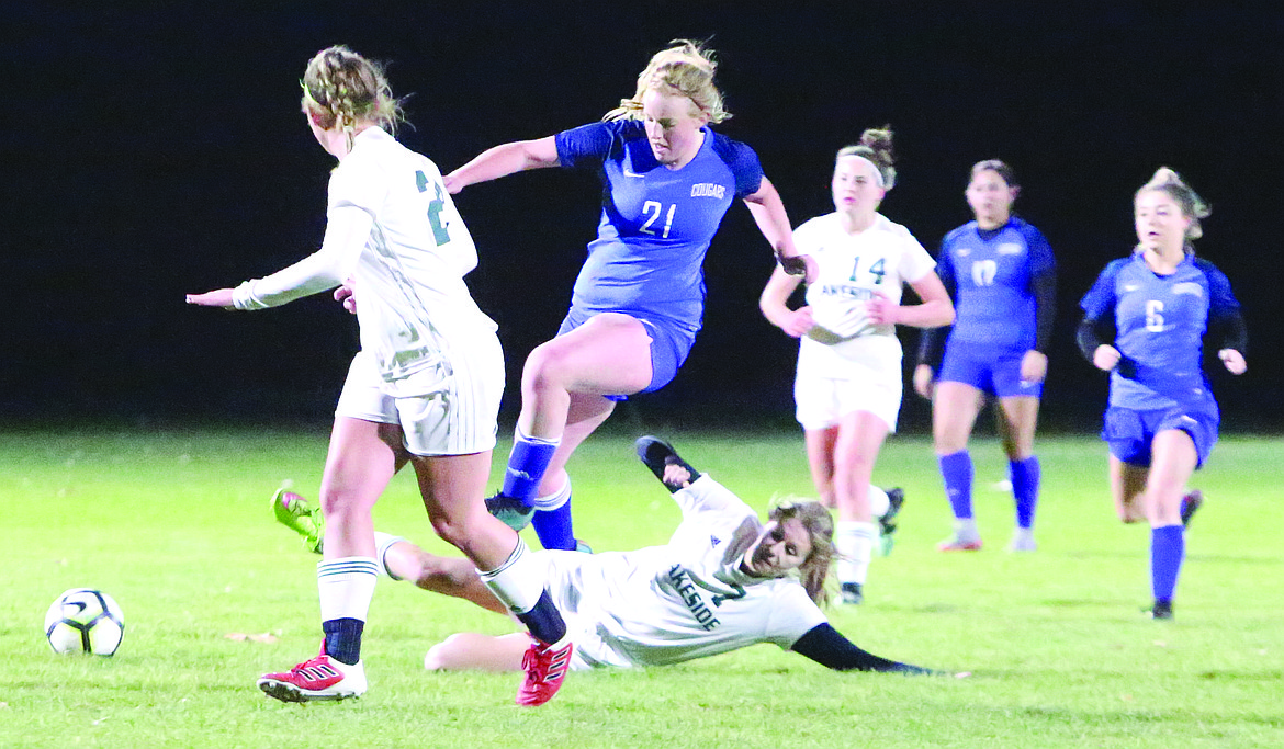 Connor Vanderweyst/Columbia Basin Herald
Warden midfielder Bailey Whitney (21) avoids a slide tackle by Lakeside defender Rachel Garrity.