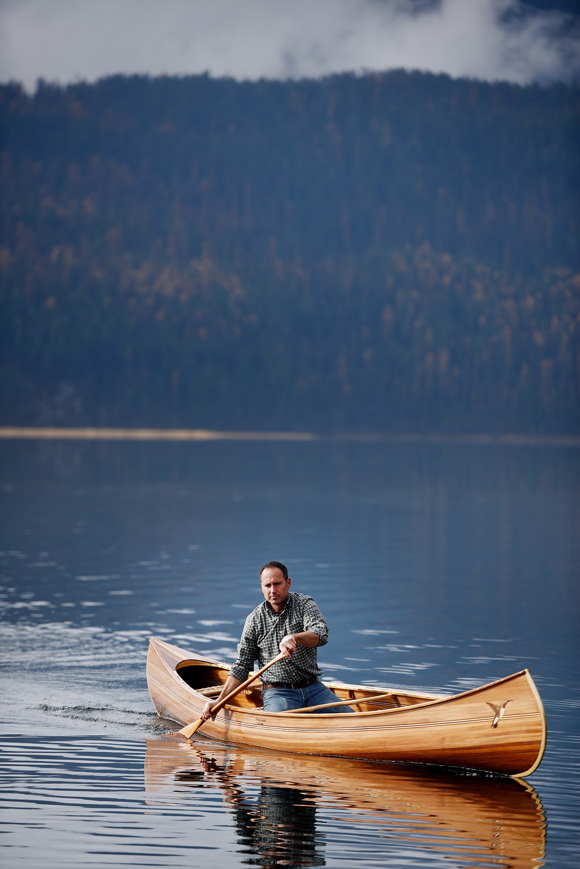 Steve Morley in a newly made canoe out on Swan Lake on Tuesday, Oct. 30. (Brenda Ahearn/Daily Inter Lake)