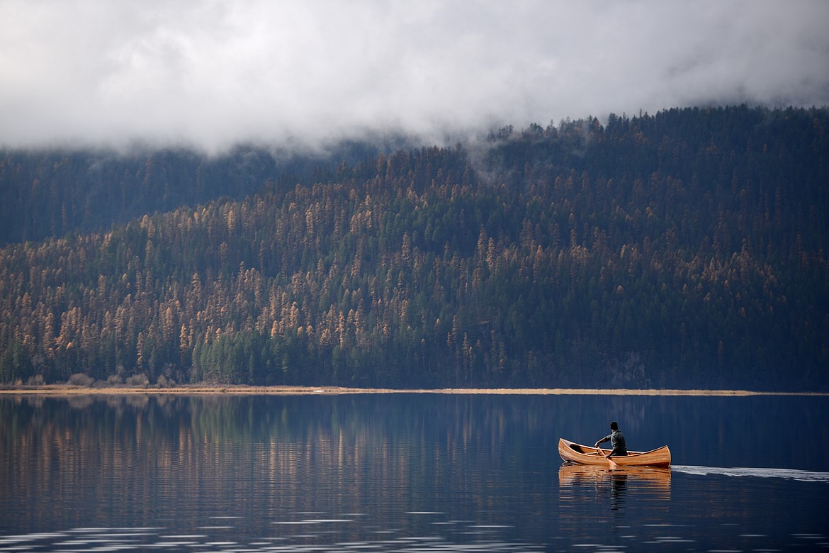 A man paddles a canoe on Swan Lake in this Oct. 30, 2018, file photo. (Brenda Ahearn/Daily Inter Lake)