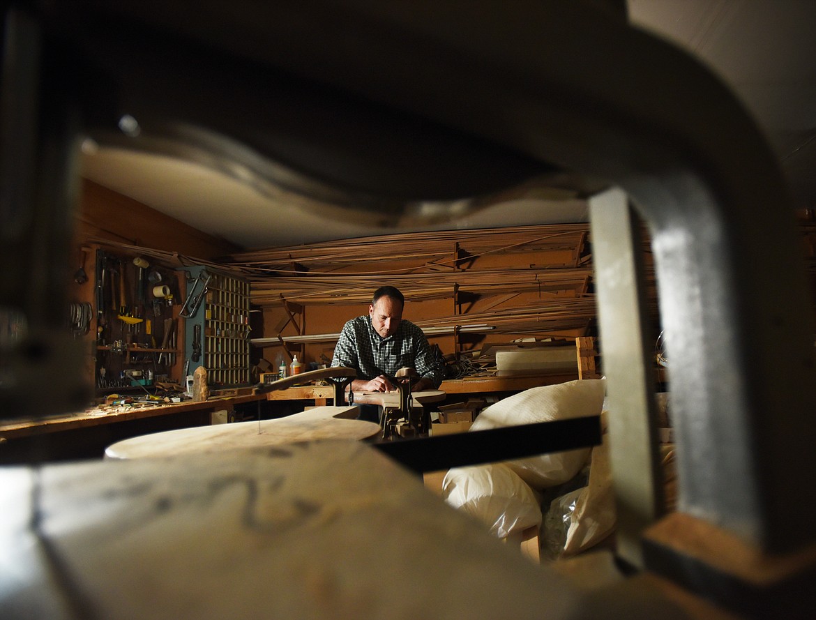 Steve Morley demonstrates the jigsaw from 1876 that is still in use at Morley Cedar Canoes in Swan Lake.
(Brenda Ahearn/Daily Inter Lake)