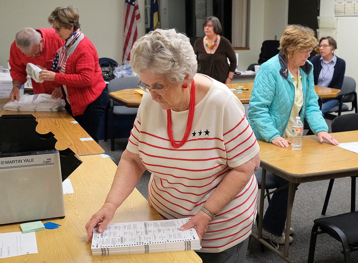 Donna Watson, foreground, and other election judges work at Lincoln County Courthouse on election night. (John Blodgett/The Western News)
