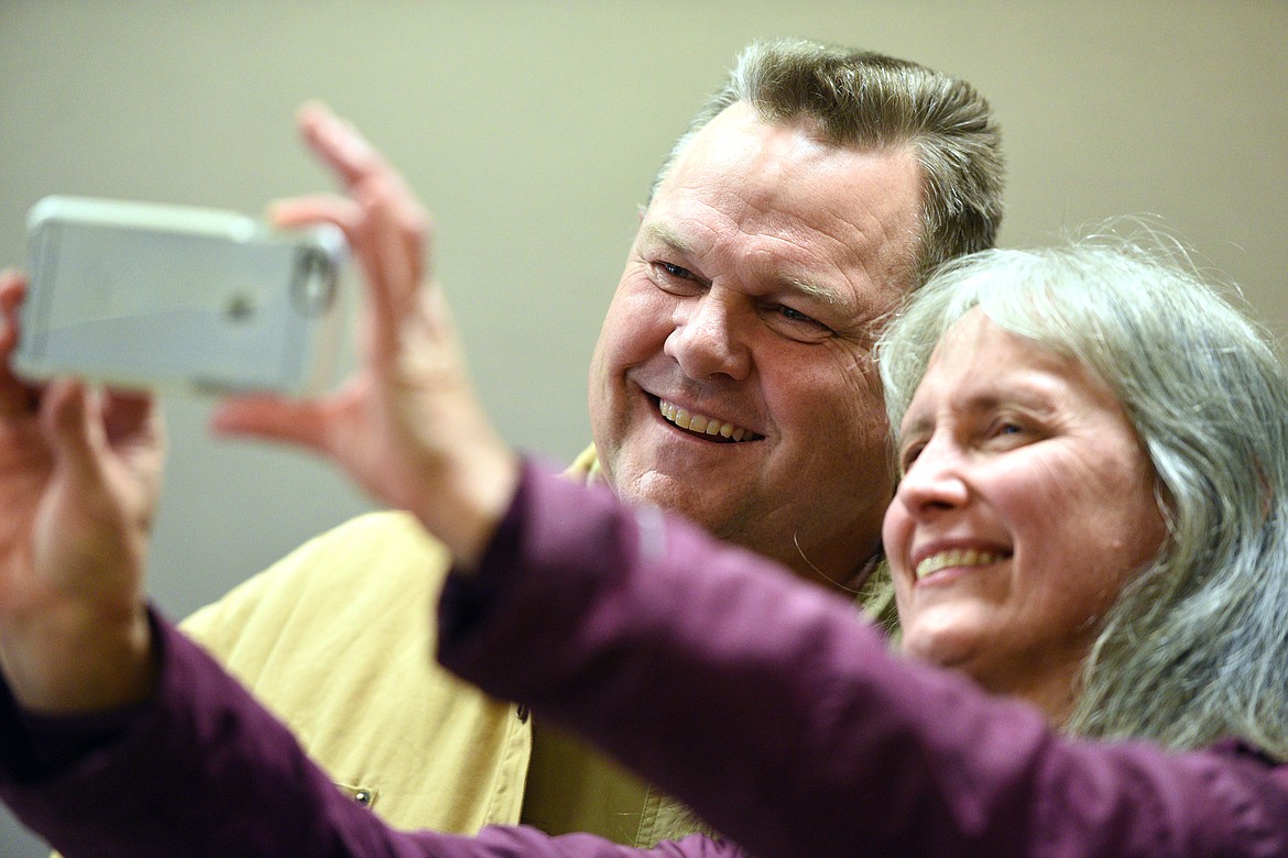 Barbara Calm, of Kila, takes a photo with Sen. Jon Tester at a Get Out the Vote rally at the Red Lion Hotel in Kalispell on Saturday. (Casey Kreider/Daily Inter Lake)