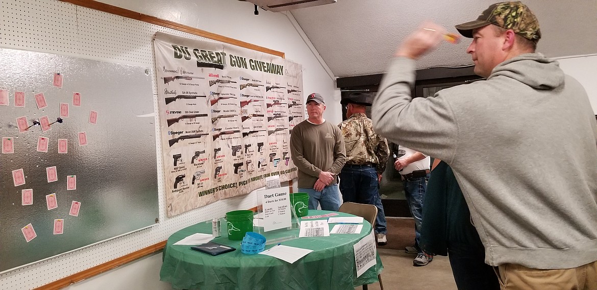 Photo by MANDI BATEMAN
Ducks Unlimited dinner and auction offered a new game this year- darts thrown at playing cards.