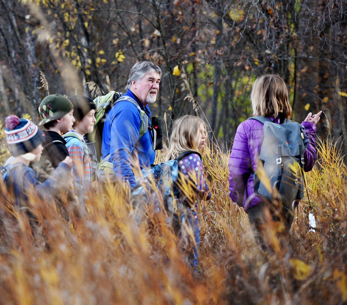 Flathead Audubon Conservation Educator Denny Olson takes a group of Kalispell Montessori students through the Owen Sowerwine Natural Area on Oct. 25. (Brenda Ahearn/Daily Inter Lake)