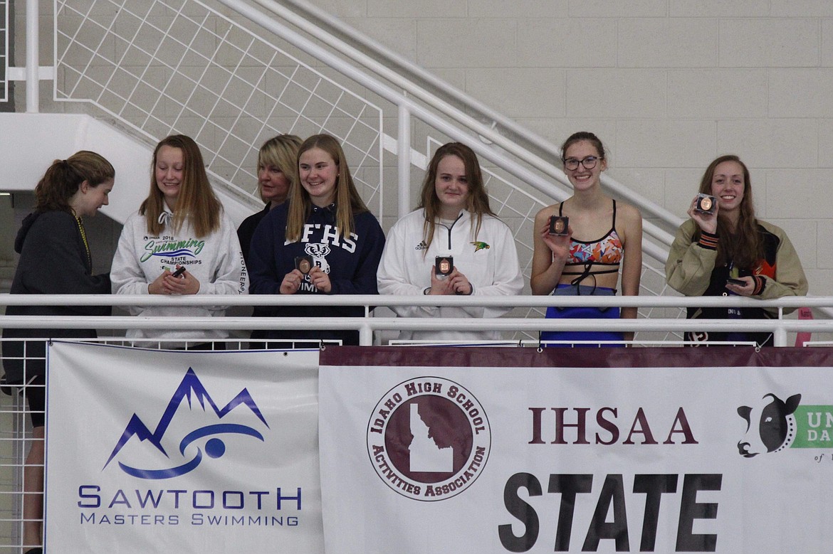 Photo by JACINDA BOKOWY
Julia Cummings (center) in the medals for the 100-yard backstroke.