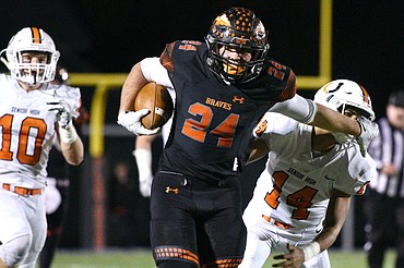 Flathead running back Blake Counts (24) stiff-arms Billings Senior defender Johnnie McClusky (14) on a 48-yard third-quarter run in a Class AA quarterfinal playoff game at Legends Stadium on Friday. (Casey Kreider/Daily Inter Lake)