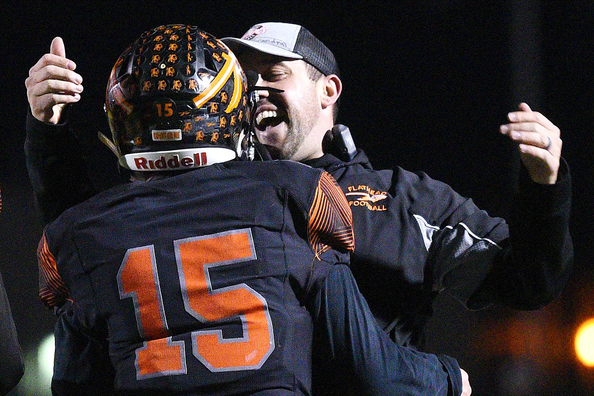 Flathead head coach Kyle Samson celebrates with quarterback Jaden MacNeil (15) after MacNeil's 28-yard touchdown run in the first quarter against Billings Senior in a Class AA quarterfinal playoff game at Legends Stadium on Friday. (Casey Kreider/Daily Inter Lake)