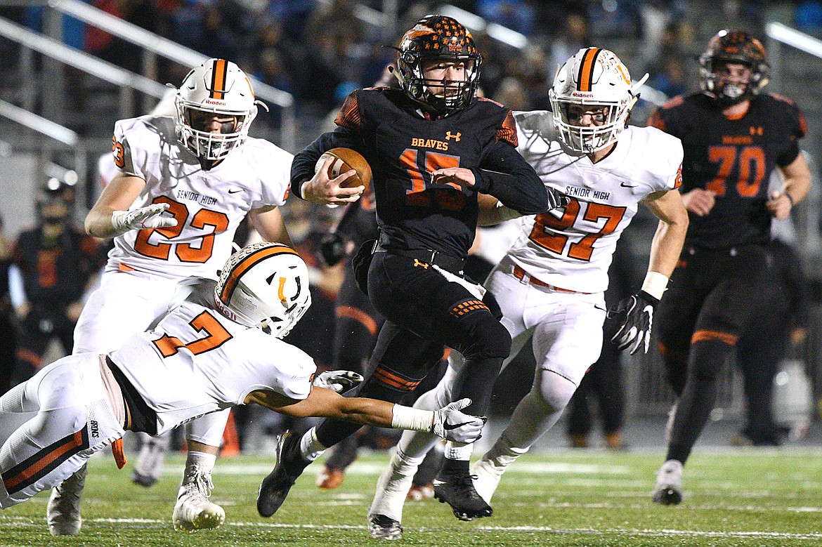 Flathead quarterback Jaden MacNeil breaks loose in the third quarter against Billings Senior in a Class AA quarterfinal playoff game at Legends Stadium on Friday. (Casey Kreider/Daily Inter Lake)